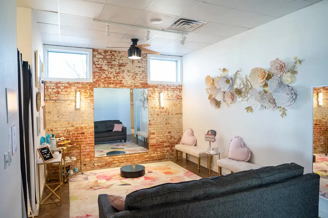 Luxury interior of Bliss Bridal Fort Worth salon with wedding dresses hanging on display